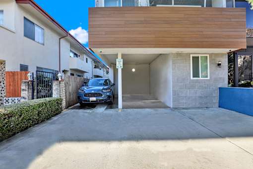 A blue car is parked in a garage.at Federal Apartments, California, 90025