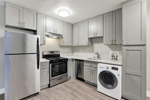 A modern kitchen with a stainless steel refrigerator and a white dishwasher.at Federal Apartments, Los Angeles, 90025