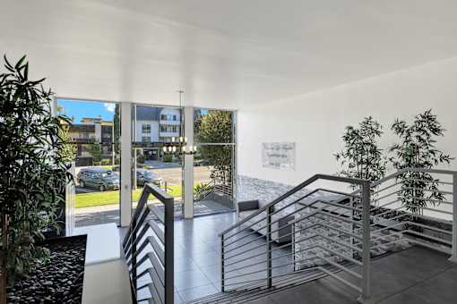A staircase with a metal railing and a plant on the side. at Chateau La Fayette, Los Angeles