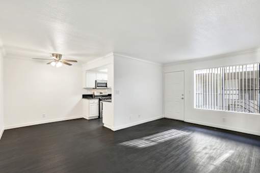 A room with a ceiling fan and a small kitchenette. at Elmwood Gardens, Burbank