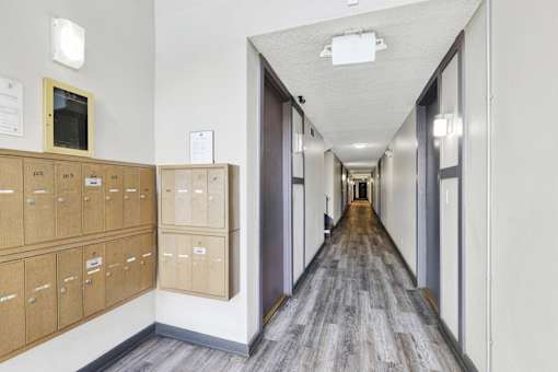 Long hallway with multiple mailboxes at Occidental Apartments, Los Angeles, CA, 90057