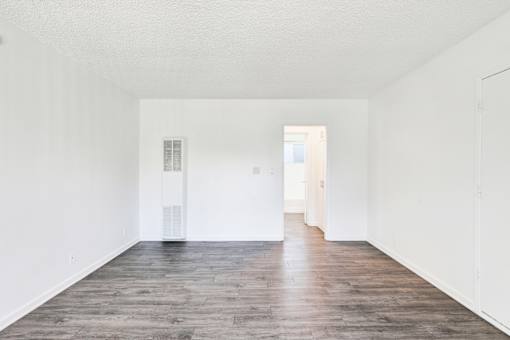 A room with white walls and wooden flooring at Sylvan Gardens,Van Nuys,91401