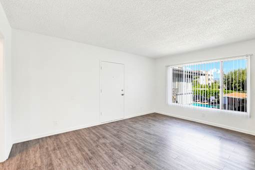 A room with a wooden floor and a window with blinds at Sylvan Gardens,Van Nuys,CA