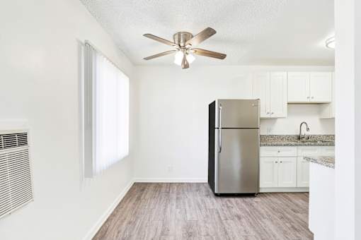 A kitchen with a stainless steel refrigerator and wooden flooring at Sylvan Gardens,Van Nuys,CA,91401