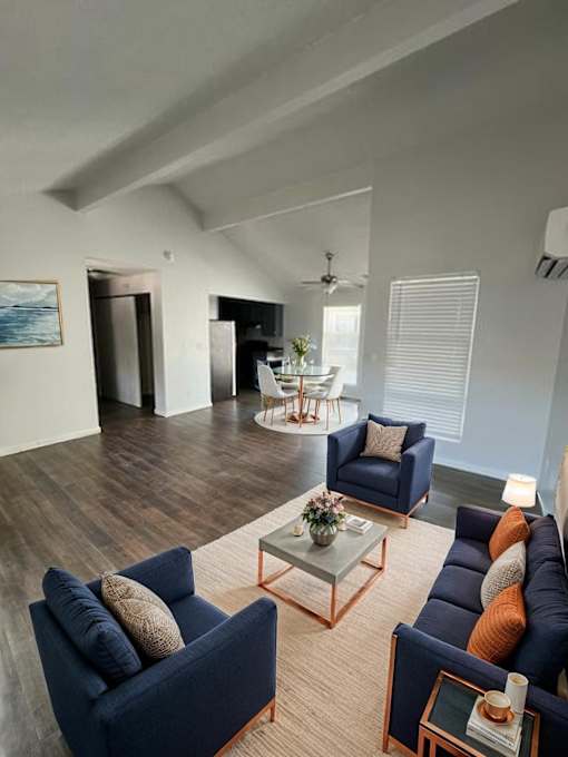 A living room with a blue couch and a coffee table.