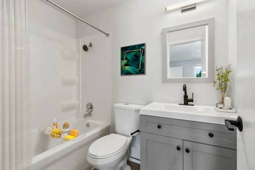 A white toilet sits next to a sink in a bathroom.