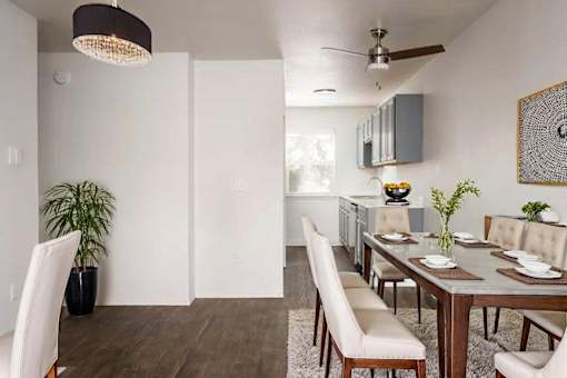 A modern dining room with a wooden table and chairs.