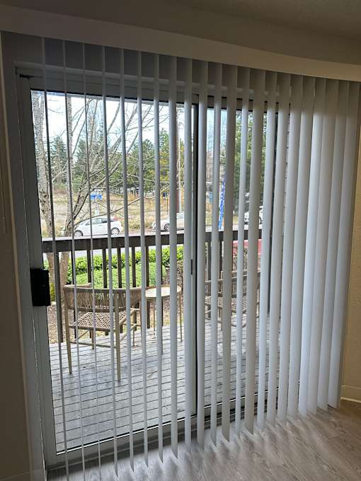 A white sliding door with a black handle.