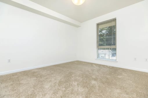 an empty room with a window and carpet  at Delano, Redmond, WA