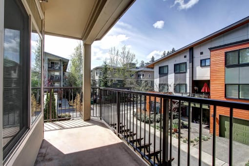 a balcony with a view of a courtyard and some buildings  at Delano, Washington, 98052