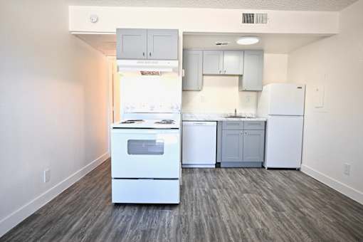A kitchen with white appliances and cabinets.