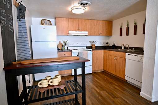A kitchen with wooden cabinets and a white refrigerator.