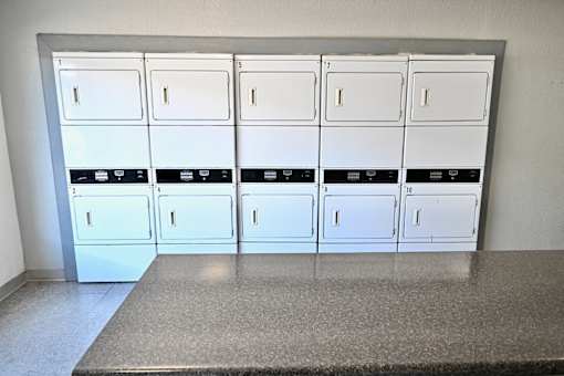 A row of white lockers in a room.