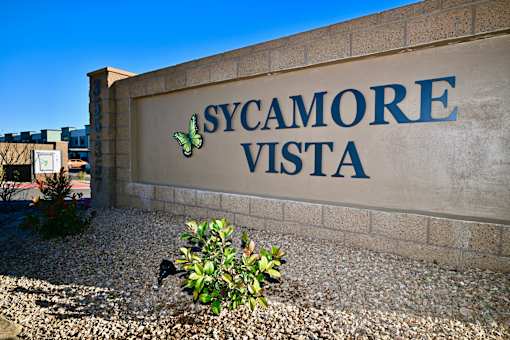 A wall with the words "Sycamore Vista" on it.