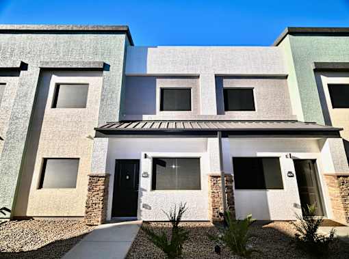 A modern house with a black door and windows.