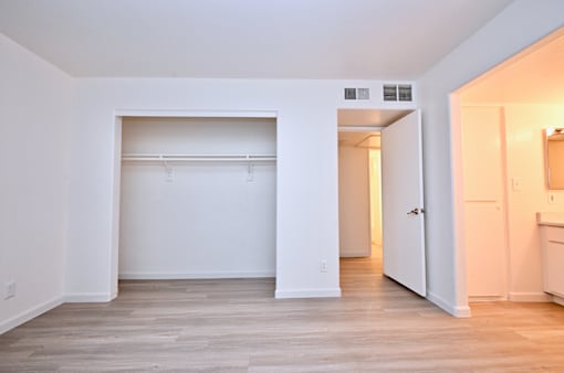 A white room with a doorway leading to another room.
