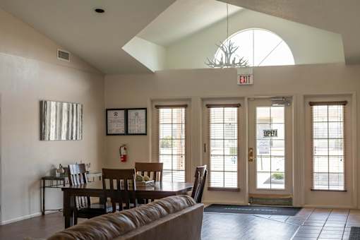 an open living room and dining room with a couch and a table at Pines at Prescott Apartments, Prescott, Arizona