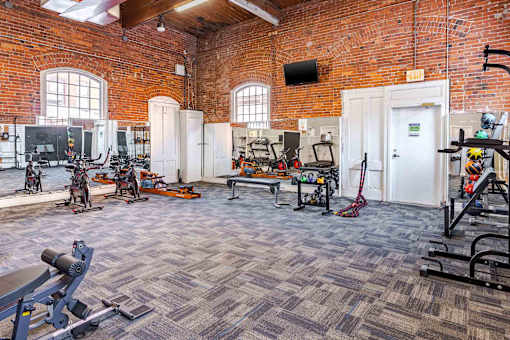 A gym with a variety of exercise equipment is shown.
