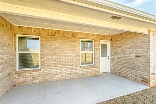 A house with a white door and windows with blinds.