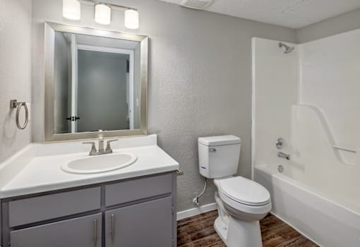 A white toilet sits next to a sink in a bathroom.