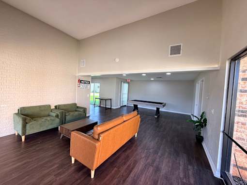 A living room with a sofa, two chairs, and a coffee table.