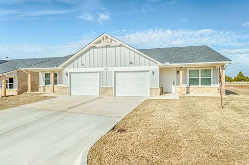 A two-story house with a garage and a driveway.