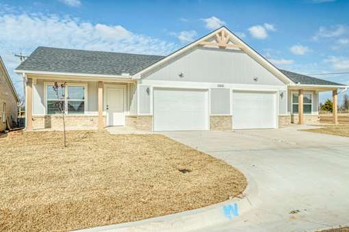 A two-car garage with a white door is visible.