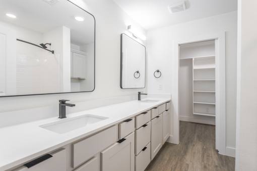 A bathroom with a sink, mirror, and medicine cabinet.