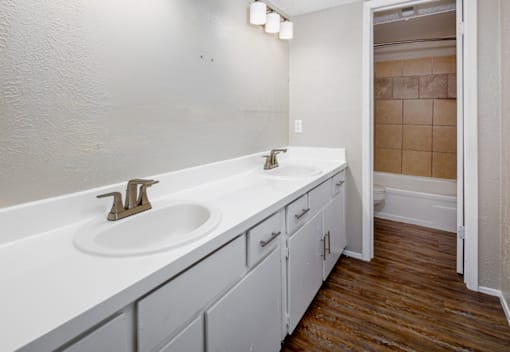 A bathroom with a white sink and a white counter top.