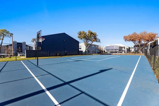 A tennis court with a blue surface and white lines.