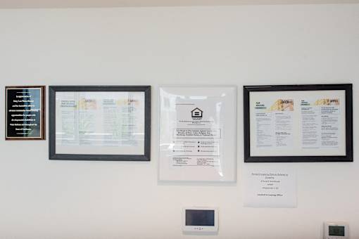 a wall with three framed pictures and a piece of paper on it