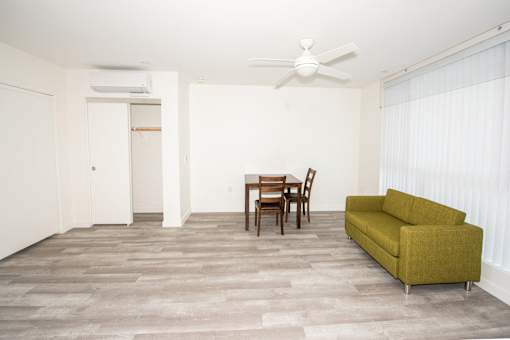 a living room with a couch and a dining room table