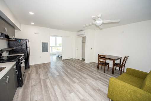a living room with a kitchen and a dining room