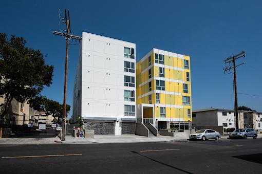 a white and yellow building on a street
