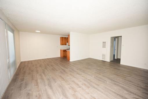 A room with wooden flooring and a white ceiling.