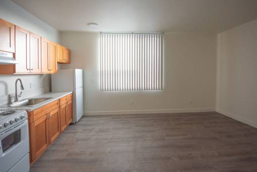 A kitchen with wooden cabinets and a white refrigerator.