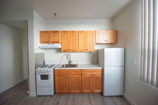A kitchen with wooden cabinets and white appliances.