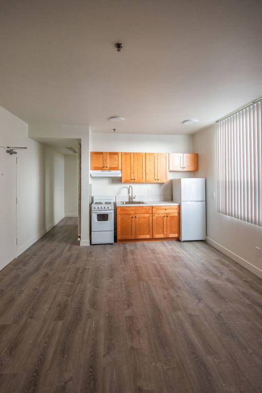 A kitchen with wooden cabinets and a white refrigerator.