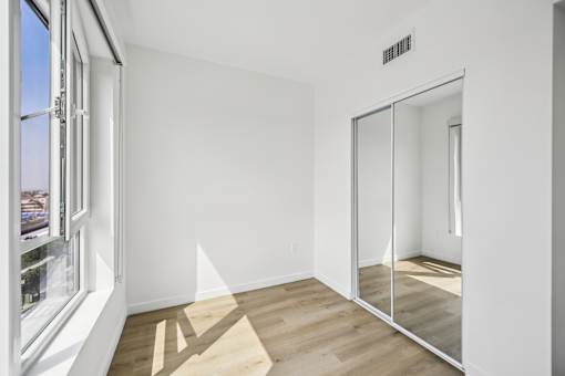 A room with a sliding glass door and a vinyl floor.