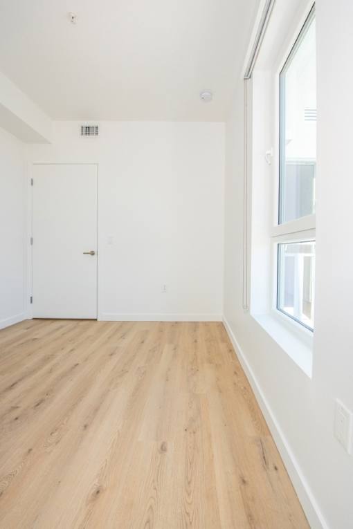 A room with a white door and a window.