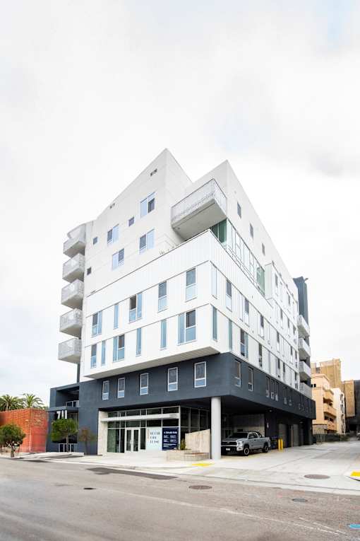 A modern multi-story building with a white and black exterior.