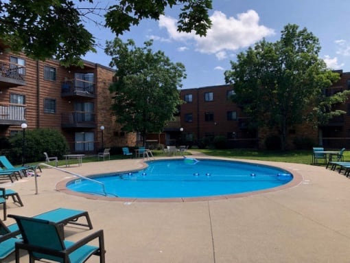 a swimming pool in front of an apartment building