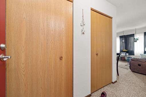 A room with a brown door and a red door.