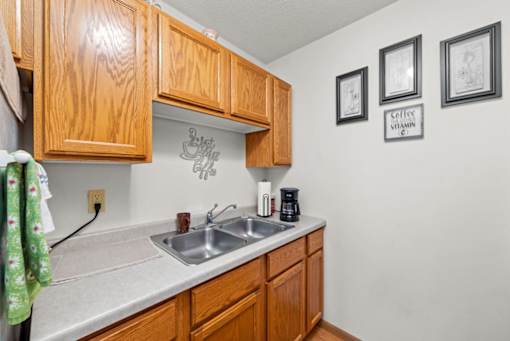 A kitchen with wooden cabinets and a sink.