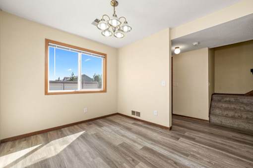 A room with a large window and a chandelier.
