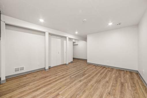A room with wooden floors and white walls.