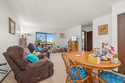 A living room with a brown recliner and a wooden table.
