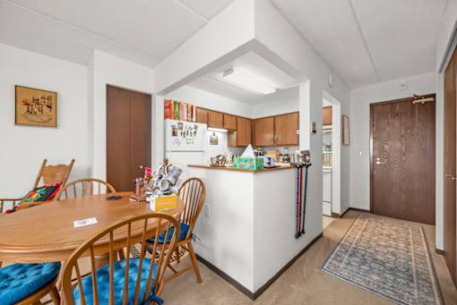 A kitchen with a table and chairs in the foreground.