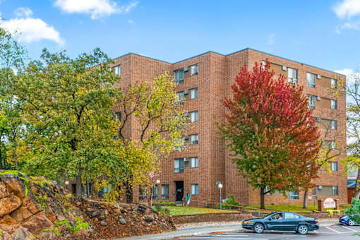 A brick building with trees in front of it.