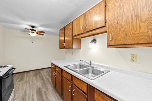 A kitchen with wooden cabinets and a white countertop.